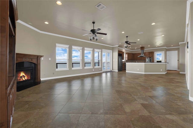 unfurnished living room with ceiling fan and crown molding