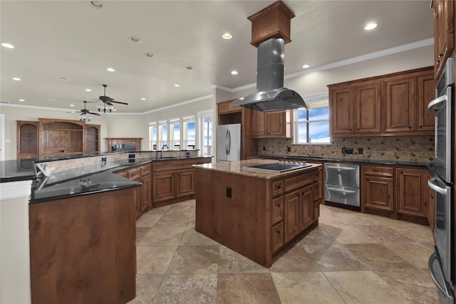 kitchen featuring appliances with stainless steel finishes, a kitchen island, island exhaust hood, and a healthy amount of sunlight