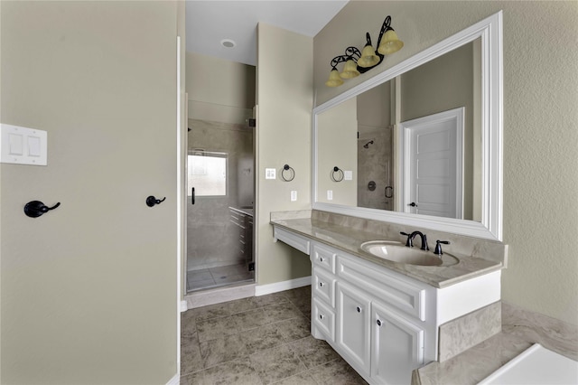 bathroom with tile patterned flooring, a shower with door, and vanity