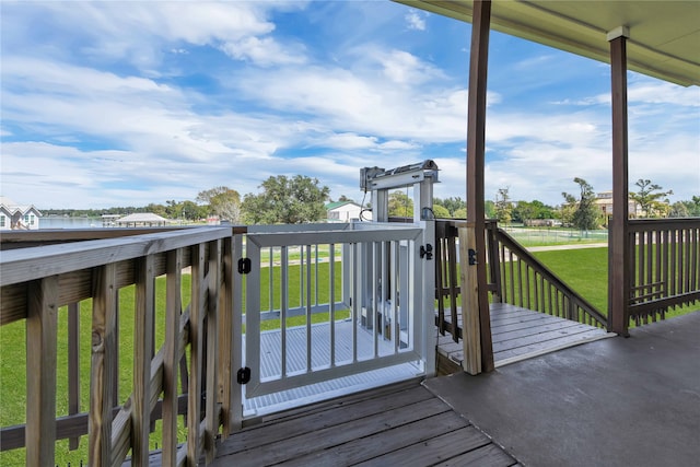 deck featuring a water view and a yard