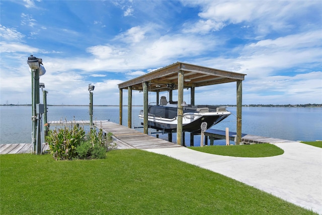 dock area with a lawn and a water view