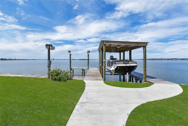 view of dock featuring a lawn and a water view