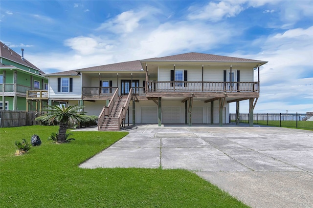 view of front facade with a garage, covered porch, and a front lawn