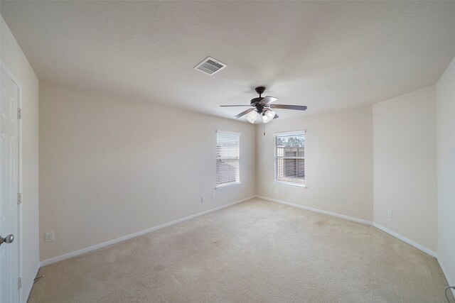 empty room with light carpet and ceiling fan