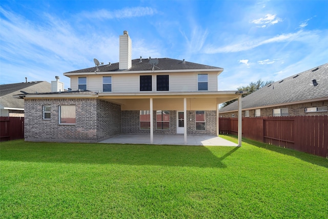 back of property featuring a yard and a patio