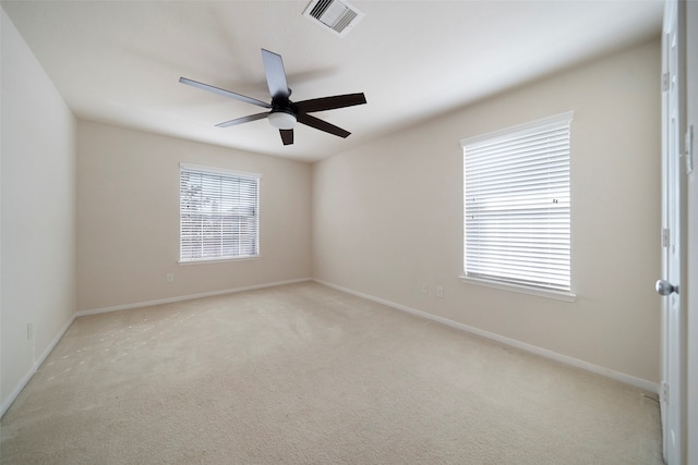 carpeted empty room featuring ceiling fan