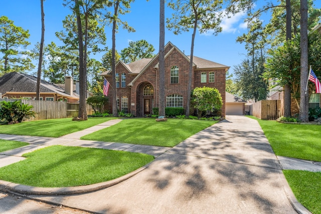 view of front of house featuring a front lawn and a garage