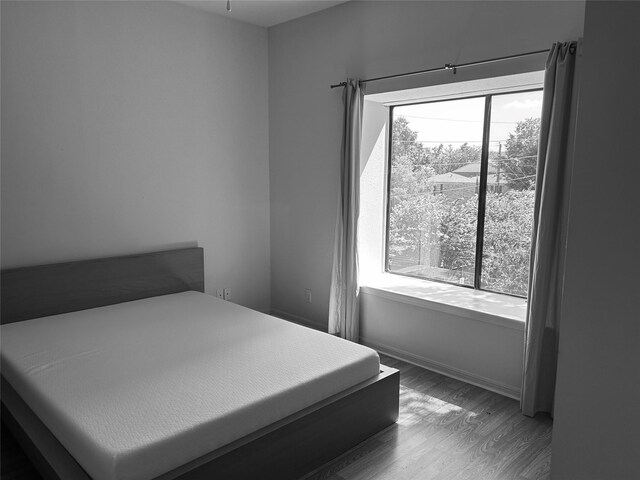2207 S Braeswood S Unit 42E, Houston, TX 77030 - bedroom with wood finished floors