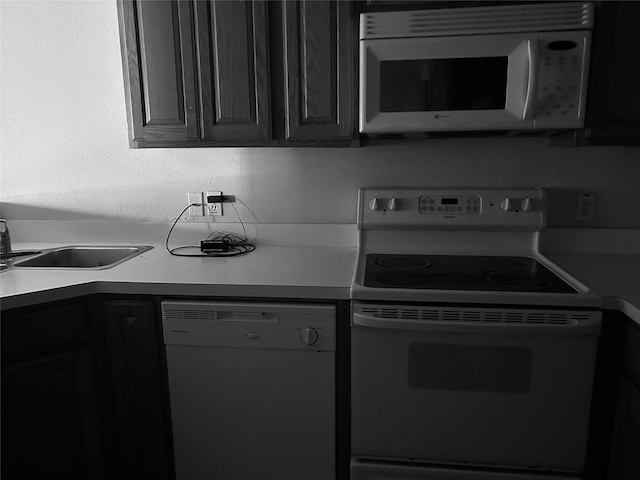 2207 S Braeswood S Unit 42E, Houston, TX 77030 - kitchen with white appliances, light countertops, and a sink
