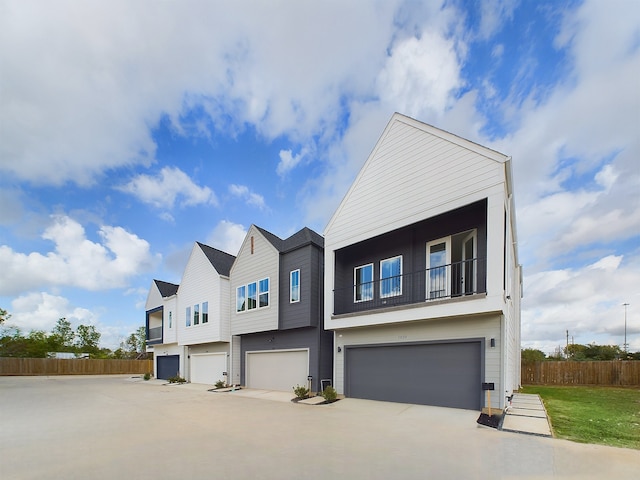 view of front of house featuring a balcony and a garage