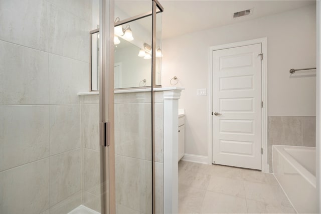 bathroom with vanity, separate shower and tub, and tile patterned floors