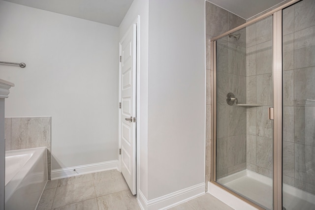 bathroom with separate shower and tub and tile patterned flooring