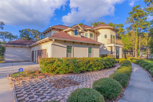 view of side of property with a balcony and a garage