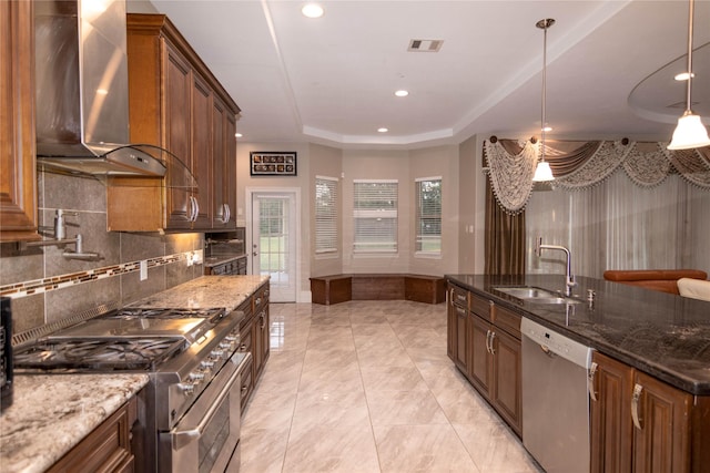 19523 Riverwalk Dr, Porter, TX 77365 - kitchen featuring appliances with stainless steel finishes, wall chimney exhaust hood, a sink, dark stone countertops, and recessed lighting