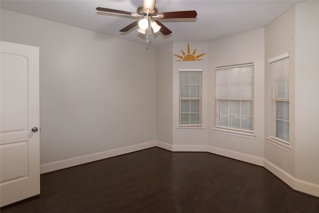 empty room featuring ceiling fan and dark hardwood / wood-style flooring