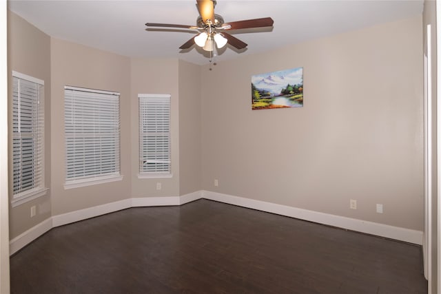 spare room with dark hardwood / wood-style floors and ceiling fan