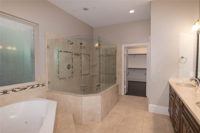 bathroom featuring tile patterned flooring, vanity, and separate shower and tub