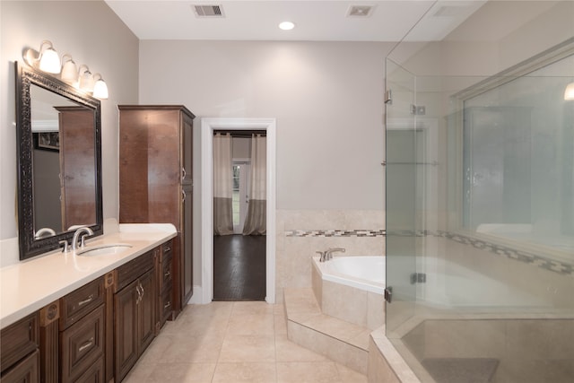 bathroom with vanity, plus walk in shower, and tile patterned flooring