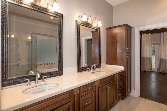 bathroom with an enclosed shower, vanity, and hardwood / wood-style flooring