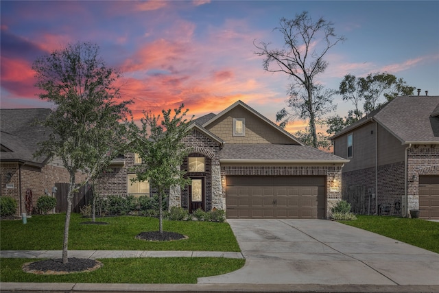 view of front of house with a garage and a yard