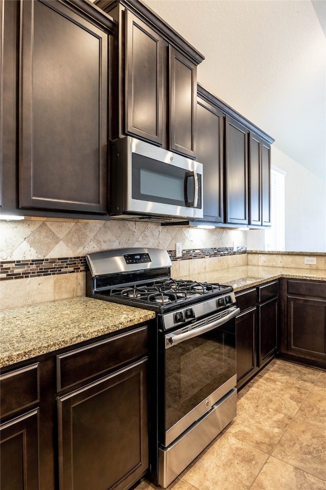 kitchen featuring appliances with stainless steel finishes, dark brown cabinetry, and tasteful backsplash