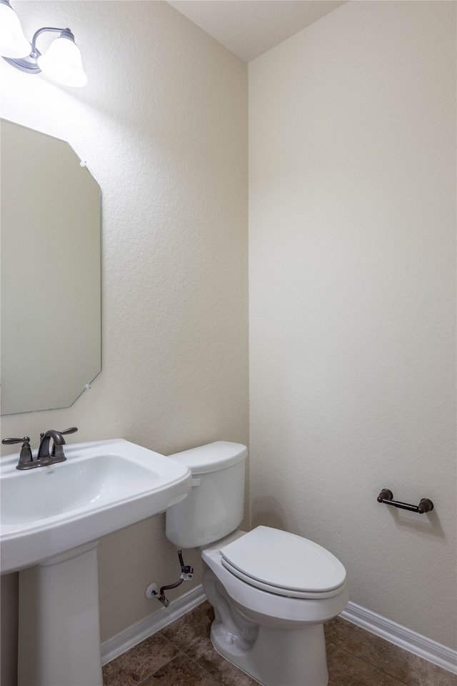 bathroom with tile patterned flooring and toilet