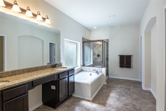 bathroom featuring vanity and shower with separate bathtub