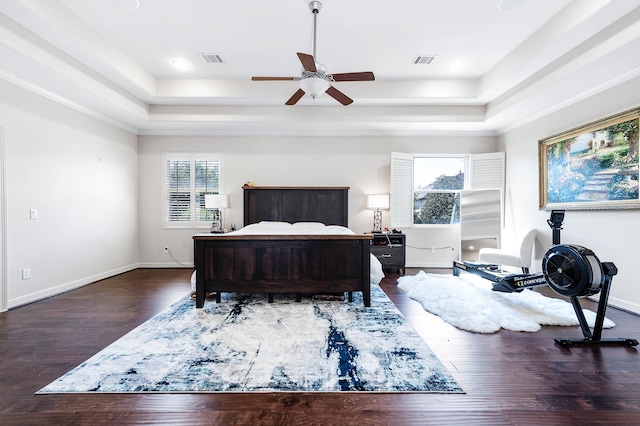 bedroom featuring ceiling fan, dark hardwood / wood-style floors, and multiple windows