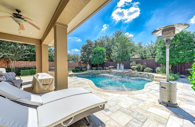 view of pool with ceiling fan, a patio area, and pool water feature