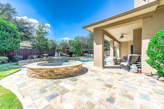 view of patio featuring ceiling fan and a fenced in pool