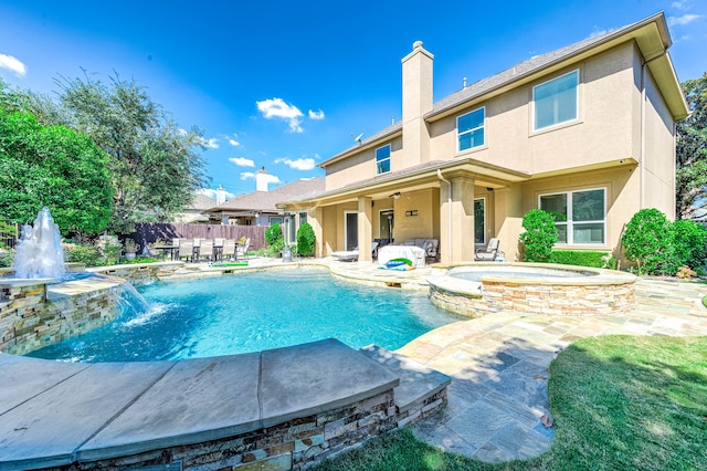 view of pool featuring a patio area, an in ground hot tub, and pool water feature