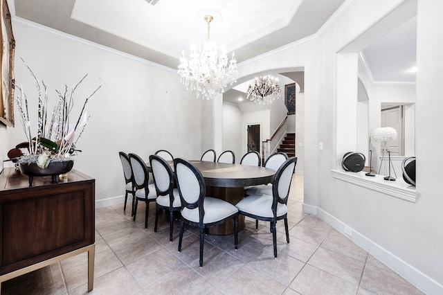 dining area featuring an inviting chandelier, a raised ceiling, light tile patterned floors, and crown molding