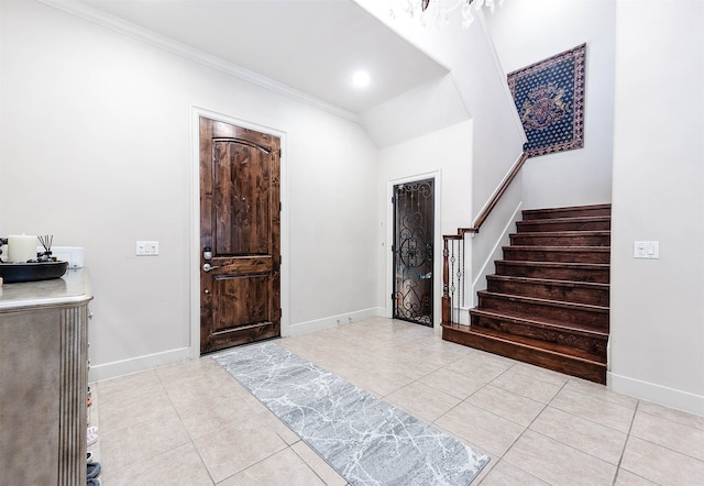 foyer featuring ornamental molding and light tile patterned flooring