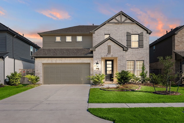 view of front facade with a garage and a yard