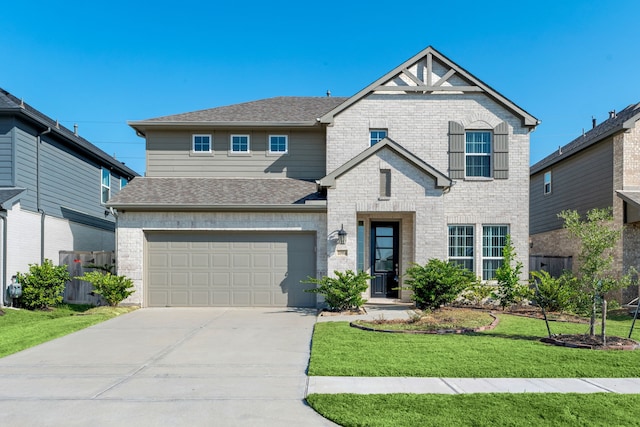 view of front facade with a front yard and a garage