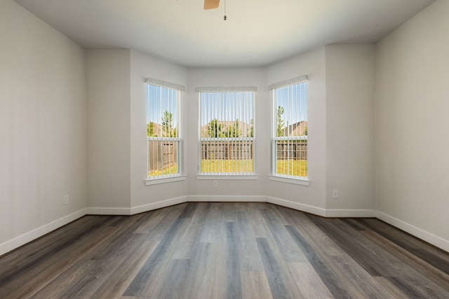 spare room with ceiling fan and dark hardwood / wood-style flooring