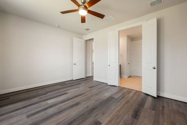 unfurnished bedroom with ceiling fan and dark hardwood / wood-style floors