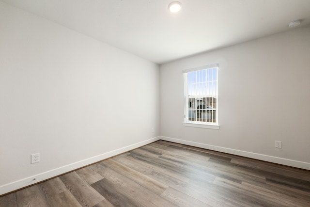 empty room with hardwood / wood-style floors