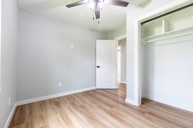 unfurnished bedroom with ceiling fan, a closet, and light hardwood / wood-style floors