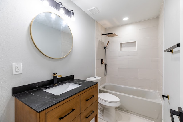 full bathroom featuring toilet, vanity, and tiled shower / bath