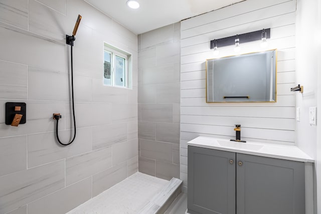 bathroom featuring vanity and a tile shower