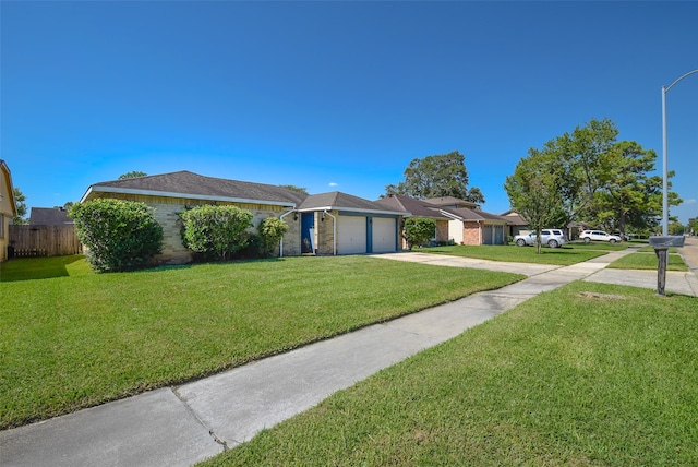 single story home with a front yard and a garage