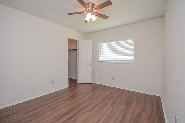 empty room featuring dark hardwood / wood-style floors and ceiling fan