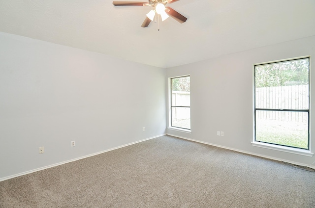 carpeted spare room with ceiling fan