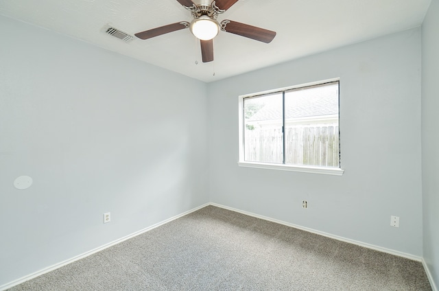 carpeted spare room with ceiling fan