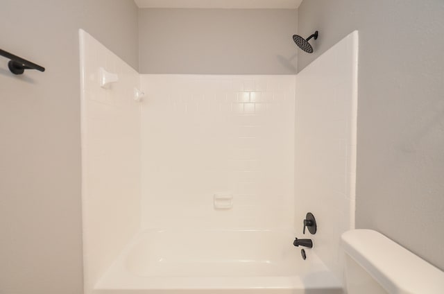 bathroom featuring toilet and shower / washtub combination