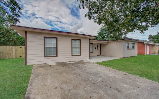 ranch-style house with a patio and a front yard