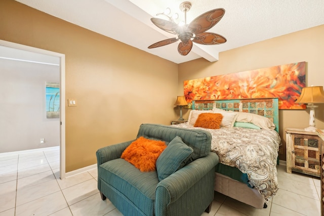 tiled bedroom with ceiling fan and a textured ceiling