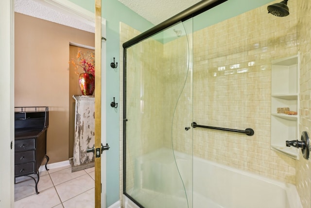 bathroom with tile patterned floors, a shower with door, and a textured ceiling