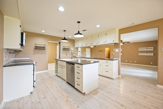 kitchen with light hardwood / wood-style flooring, range, decorative light fixtures, and stainless steel dishwasher